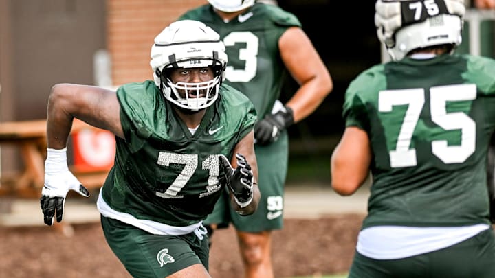 Michigan State's Kristian Phillips runs an offensive line drill during the first day of football camp on Tuesday, July 30, 2024, in East Lansing.