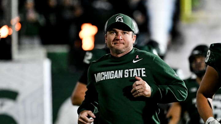 Michigan State's head coach Jonathan Smith runs onto the field with the team before the gam against Michigan Saturday, Oct. 25, 2025, at Spartan Stadium in East Lansing. Michigan State's head coach Jonathan Smith runs onto the field with the team before the gam against Michigan Saturday, Oct. 25, 2025, at Spartan Stadium in East Lansing.