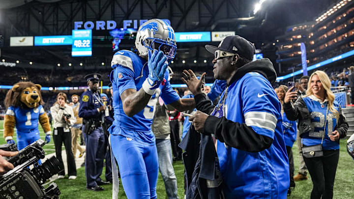 Detroit Lions receiver Jameson Williams meets Hip-hop artist Flavor Flav during an NFL game against the Green Bay Packers