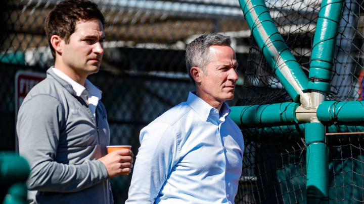 Detroit Tigers chairman and CEO Chris Ilitch and president of baseball operations Scott Harris watch practice during spring training at TigerTown in Lakeland, Fla.