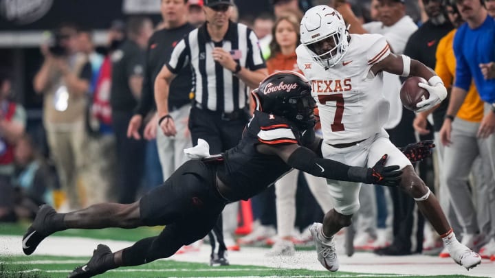 Oklahoma State linebacker Xavier Benson (1) dives to tackle Texas running back Keilan Robinson (7) in the first quarter of the Big 12 Conference Championship game at AT&T Stadium in Arlington, Texas, Saturday, Dec. 2, 2023