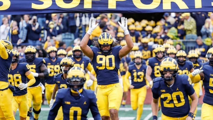 Michigan takes the field, including defensive end Mike Morris (90), ahead of the Maryland game at Michigan Stadium in Ann Arbor on Saturday, Sept. 24, 2022.

09242022 Umfbextra 4 m go blue, michigan flag