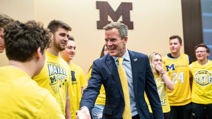 U-M's new men's basketball head coach Dusty May shakes hands with students section Maize Rage members during an introductory press conference at Junge Family Champions Center in Ann Arbor on Tuesday, March 26, 2024.