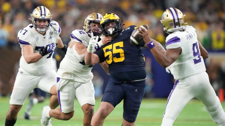 Michigan defensive lineman Mason Graham looks to tackle Washington quarterback Michael Penix Jr. during the second half of U-M's 34-13 win in the College Football Playoff national championship game in Houston on Monday, Jan. 8, 2024.