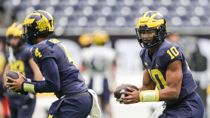 Michigan quarterback Alex Orji (10) next to quarterback Jayden Denegal (4) practice during open practice at NRG Stadium in Houston, Texas on Saturday, Jan. 6, 2024.