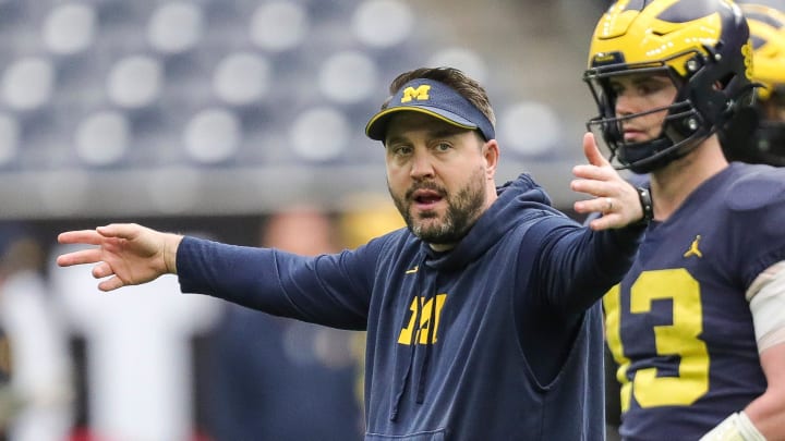 Michigan quarterbacks coach Kirk Campbell talks to players during open practice at NRG Stadium in Houston, Texas on Saturday, Jan. 6, 2024.