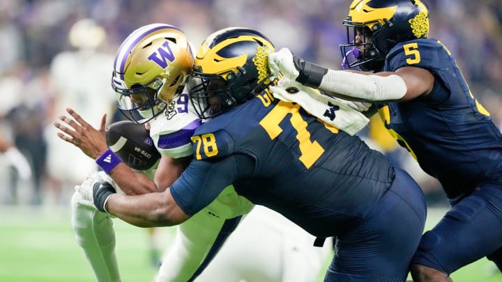 Michigan defensive lineman Kenneth Grant reaches out to sack Washington quarterback Michael Penix Jr. in the second quarter during the College Football Playoff national championship game against Washington at NRG Stadium in Houston, Texas on Monday, Jan. 8, 2024.