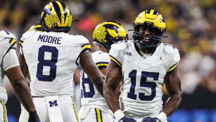 Michigan linebacker Ernest Hausmann celebrates a tackle against Iowa running back Leshon Williams during the first half of the Big Ten championship game at Lucas Oil Stadium in Indianapolis, Ind. on Saturday, Dec. 2, 2023.