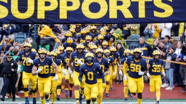 Michigan takes the field ahead of the Maryland game at Michigan Stadium in Ann Arbor on Saturday, Sept. 24, 2022.

09242022 Umfbextra 3 m go blue, michigan flag