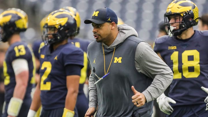 Michigan tight end coach Grant Newsome watches warmups during open practice at NRG Stadium in Houston, Texas on Saturday, Jan. 6, 2024.