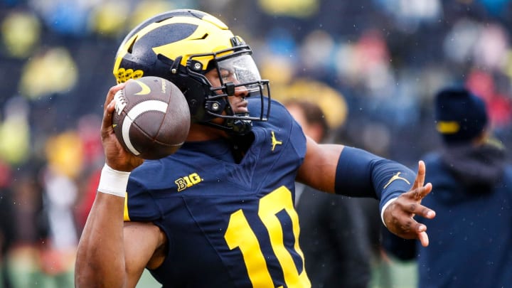 Michigan quarterback Alex Orji (10) warms up before the Indiana game at Michigan Stadium in Ann Arbor on Saturday, Oct. 14, 2023.