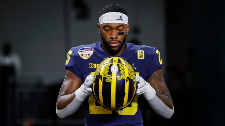 Michigan running back Hassan Haskins (25) takes the field for warm up before the kickoff of the Orange Bowl against Georgia at the Hard Rock Stadium in Miami, Fla. on Friday, Dec. 31, 2021.