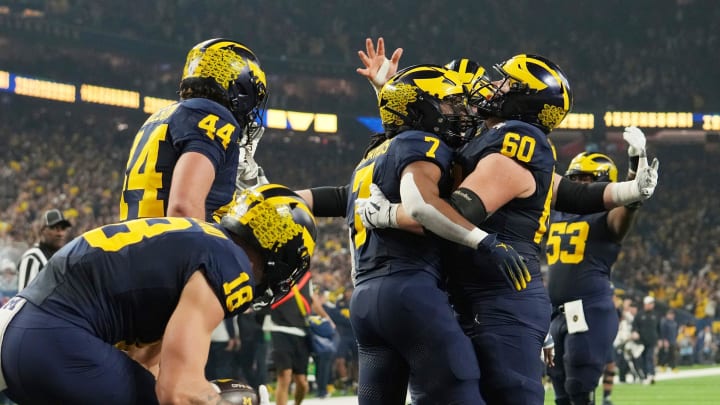 Michigan running back Donovan Edwards celebrates with Michigan offensive lineman Drake Nugent after a touchdown in the first quarter during the College Football Playoff national championship game against Washington at NRG Stadium in Houston on Monday, Jan. 8, 2024.