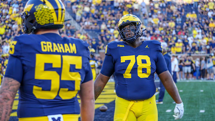 Michigan defensive linemen Mason Graham (55) and Kenneth Grant (78) warm up before the start of the game against Fresno State at Michigan Stadium in Ann Arbor on Saturday, Aug. 31, 2024.