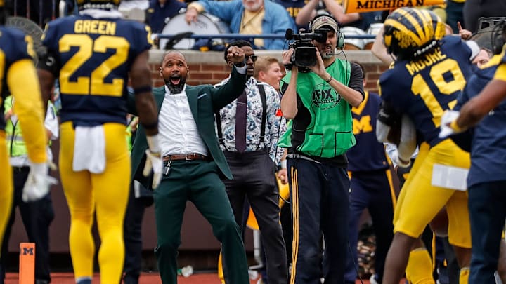 Charles Woodson, center, celebrates an interception made by Michigan defensive back R.J. Moten (6) against Maryland during the second half at the Michigan Stadium in Ann Arbor on Saturday, Sept. 24, 2022.