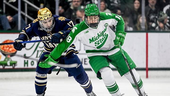 Michigan State's Ryker Lee, right, moves the puck against Notre Dame's Pano Fimis during the third period on Thursday, Feb. 19, 2026, at the Munn Ice Arena in East Lansing. Michigan State's Ryker Lee, right, moves the puck against Notre Dame's Pano Fimis during the third period on Thursday, Feb. 19, 2026, at the Munn Ice Arena in East Lansing.