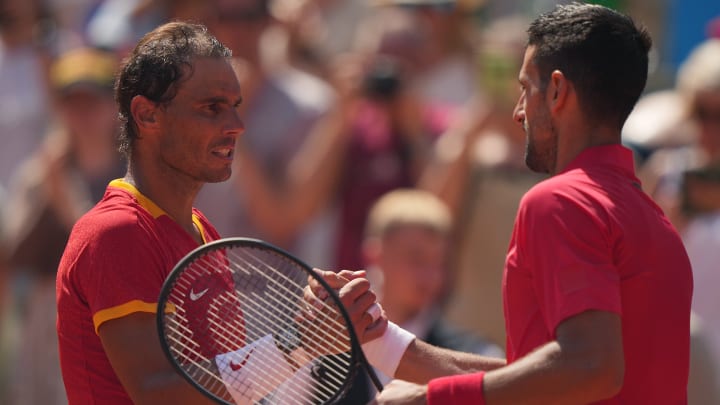 Rafael Nadal and Novak Djokovic shake hands after their round two match at the 2024 Paris Olympics.