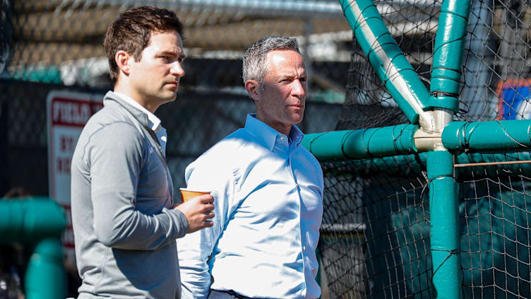 Detroit Tigers chairman and CEO Chris Ilitch and president of baseball operations Scott Harris watch practice during spring training at TigerTown in Lakeland, Fla. on Tuesday, Feb. 20, 2024.