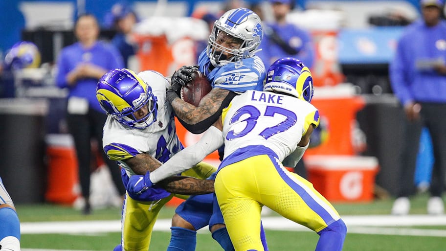 Detroit Lions running back David Montgomery runs against Los Angeles Rams safety Quentin Lake during the first half of the NFC wild-card game at Ford Field in Detroit on Sunday, Jan. 14, 2024. | Junfu Han / USA TODAY NETWORK