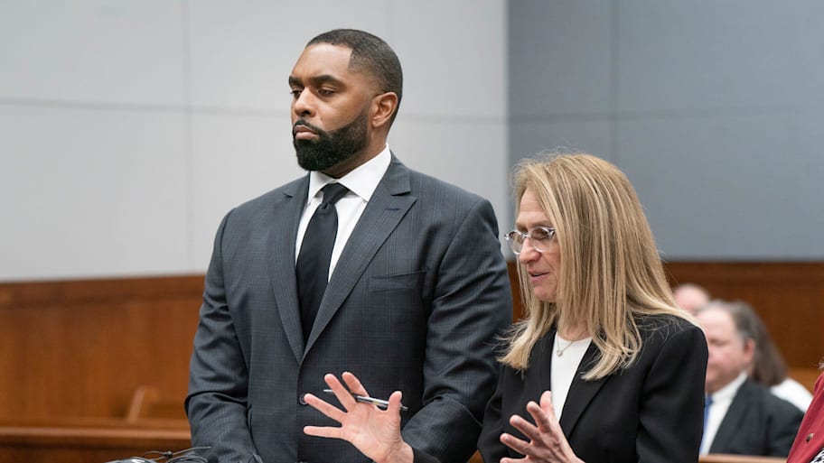 Former University of Michigan head football coach Sherrone Moore, left, stands with his attorney Ellen Michaels.