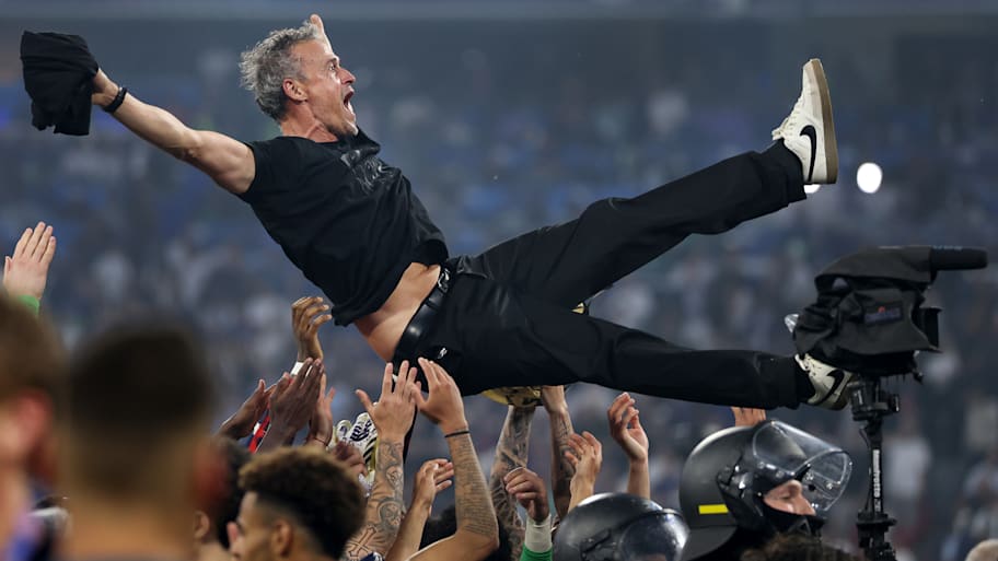Luis Enrique is thrown into the air by players of Paris Saint-Germain 