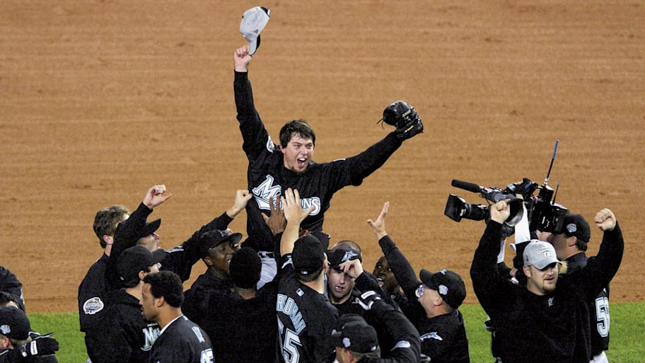 Florida Marlins pitcher Josh Beckett celebrates  with team after winning Game 6 and series vs New York Yankees