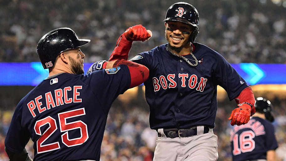 Red Sox outfielder Mookie Betts celebrates with teammate Steve Pearce