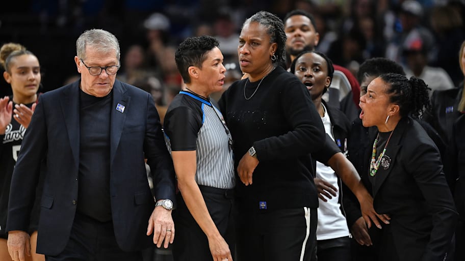 UConn women’s basketball coach Geno Auriemma walks away South Carolina’s Dawn Staley shouts at him after Final Four game.