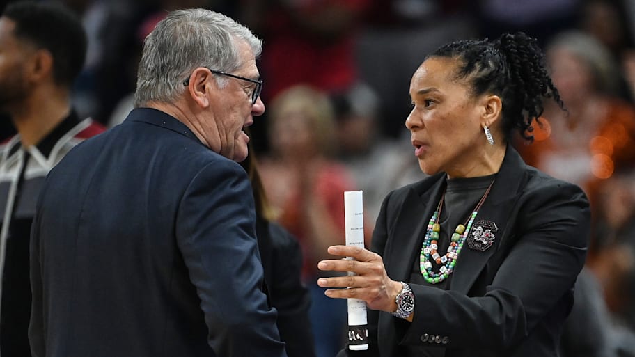 UConn Huskies women’s basketball coach Geno Auriemma and South Carolina Gamecocks’ Dawn Staley talk after a game.