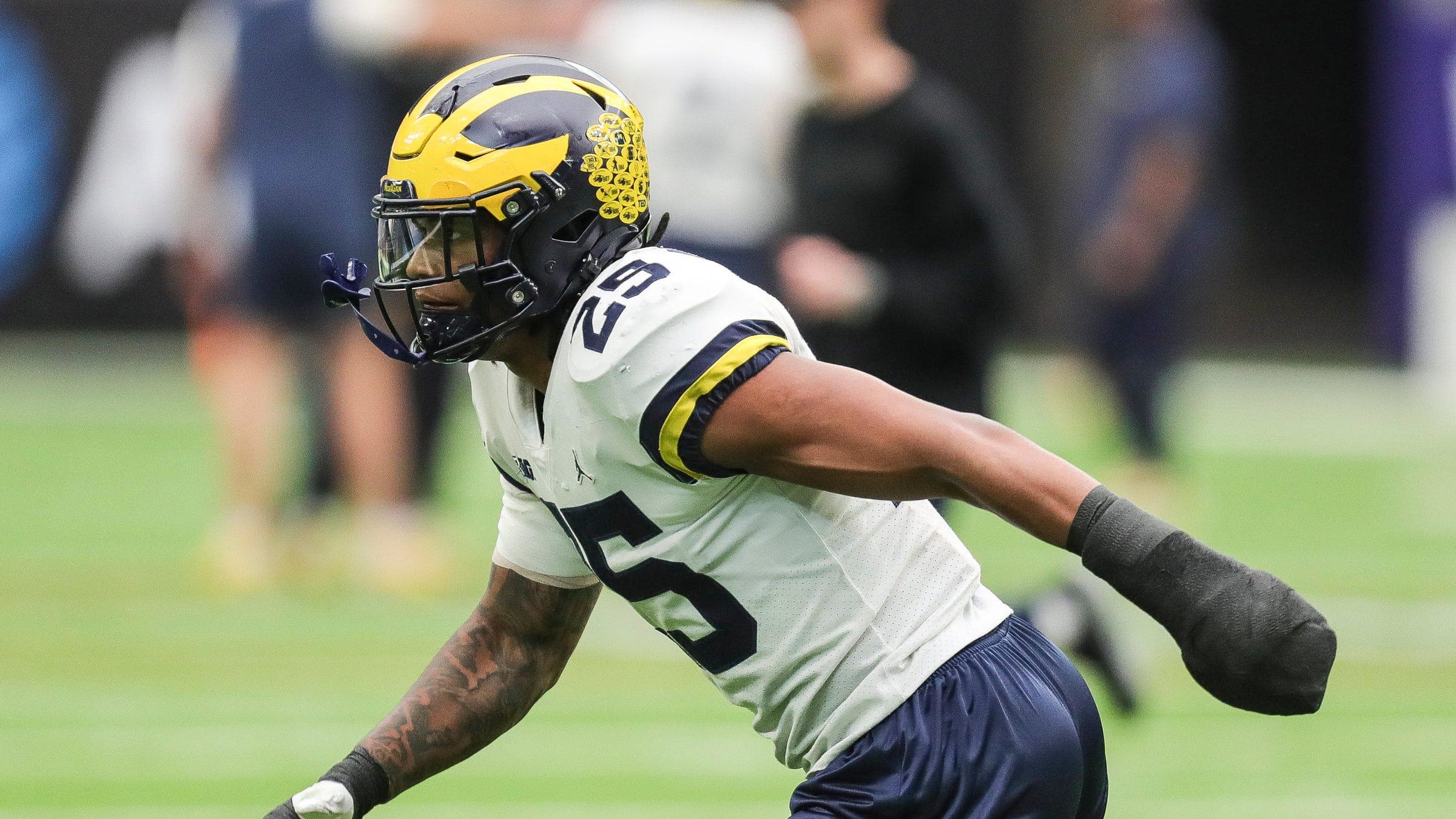 Michigan linebacker Junior Colson (25) runs a drill during open practice at NRG Stadium in Houston.