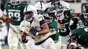 Penn State Nittany Lions runnning back Kaytron Allen attempts to break a tackle against the Michigan State Spartans.