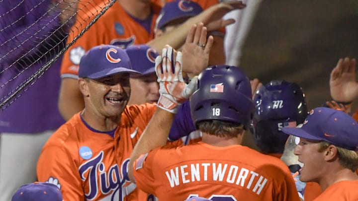 Clemson Head Coach Erik Bakich, left, congratulates Andrew Ciufo (5) and TP Wentworth (18) scoring to tie the game on a Clemson outfielder Cam Cannarella (10) double against University of South Carolina Upstate during the bottom of the fifth inning at the NCAA baseball Clemson Regional at Doug Kingsmore Stadium in Clemson, S.C. Friday, May 30, 2025.