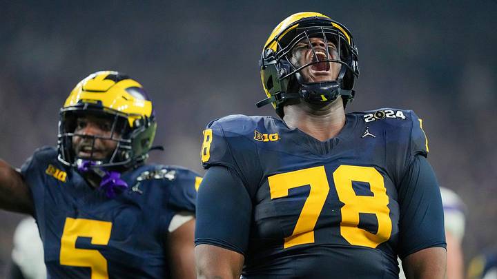 Michigan defensive lineman Kenneth Grant celebrates a sack on Washington quarterback Michael Penix Jr. during the College Football Playoff national championship game against Washington at NRG Stadium in Houston, Texas, on Monday, Jan. 8, 2024.