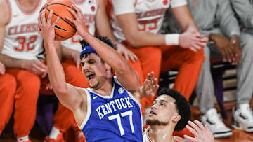 Dec 3, 2024; Clemson, South Carolina, USA; Kentucky guard Kerr Kriisa (77) rebounds near Clemson guard Chase Hunter (1) during the first half at Littlejohn Coliseum. Mandatory Credit: Ken Ruinard-Imagn Images