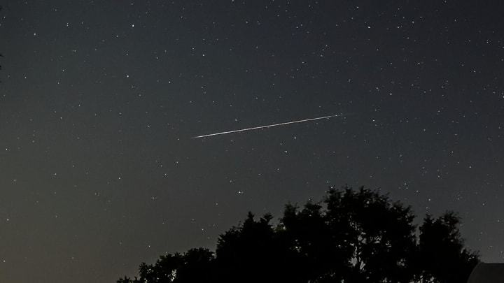 A bright Perseid meteor appears in the northern sky during the Perseid meteor shower on Aug. 12, 2021.