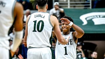 Michigan State's Jeremy Fears Jr., right, celebrates with Szymon Zapala after Zapala scored and drew a Florida Atlantic foul during the second half on Saturday, Dec. 21, 2024, in East Lansing.
