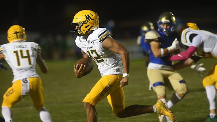Bishop Manogue’s Brandon Mann looks to run while taking on Reed in Sparks on Oct. 4, 2024.