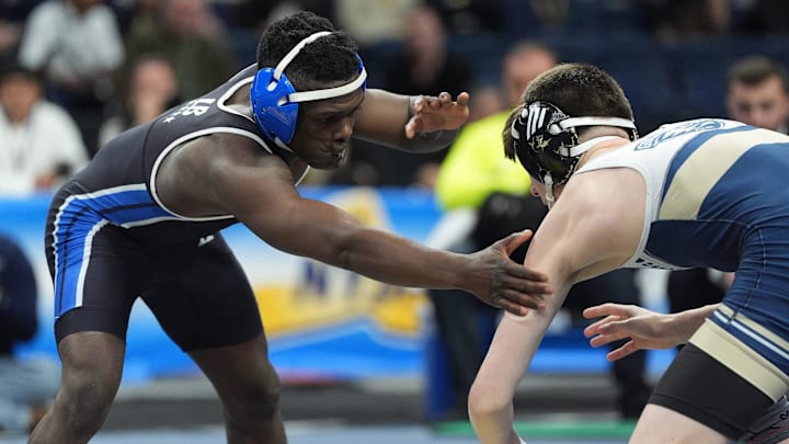 Long Beach's Dunia Sibomana, left, competed against Newburgh's Cooper Merli (currently at New York Military Academy for his senior season) in the New York State 116-pound championship bout in March. Sibomana came away with the state title.