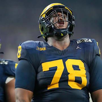 Michigan defensive lineman Kenneth Grant celebrates a sack on Washington quarterback Michael Penix Jr. during the College Football Playoff national championship game against Washington at NRG Stadium in Houston, Texas, on Monday, Jan. 8, 2024.