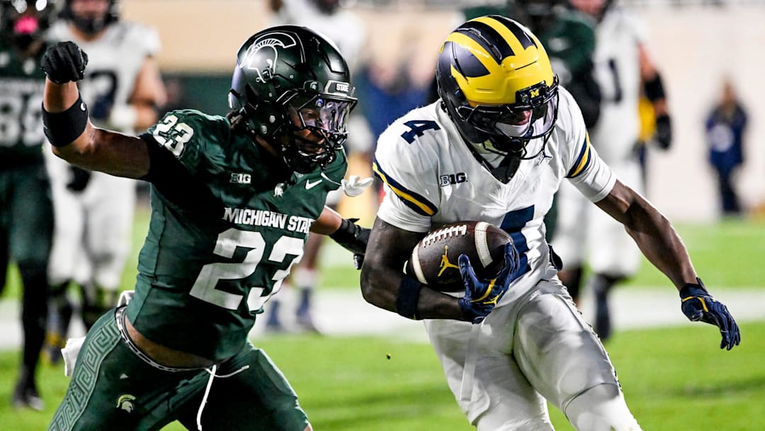 Michigan State's Darius Snow, left, tackles Michigan's Andrew Marsh during the third quarter on Saturday, Oct. 25, 2025, at Spartan Stadium in East Lansing.