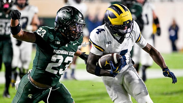 Michigan State's Darius Snow, left, tackles Michigan's Andrew Marsh during the third quarter on Saturday, Oct. 25, 2025, at Spartan Stadium in East Lansing.