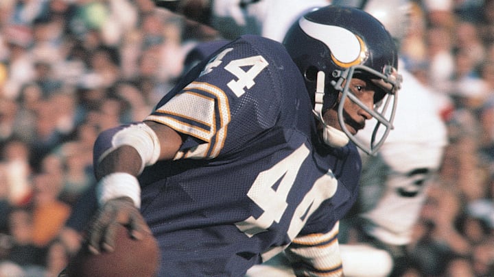 Chuck Foreman (44), who began his football journey at Maryland's Frederick High, runs the ball for the Minnesota Vikings during Super Bowl XI, in 1977; at the Rose Bowl.