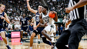 Michigan State's Coen Carr, right, moves the ball as Monmouth's Jack Collins defends during the second half on Monday, Nov. 4, 2024, at the Breslin Center in East Lansing.