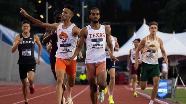 June 7, 2023; Austin, TX, USA; Texas runner Yusuf Bizimana and Oklahoma State runner Mehdi Yanouri celebrate their finishes in the 800 meter semifinals during the 2023 NCAA outdoor track and field championships