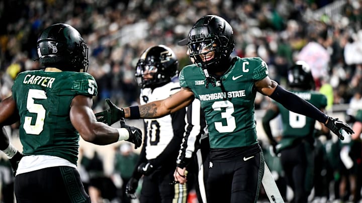 Michigan State's Montorie Foster Jr., right, celebrates with Nathan Carter, left, after Carter's touchdown against Purdue during the second quarter on Friday, Nov. 22, 2024, at Spartan Stadium in East Lansing.