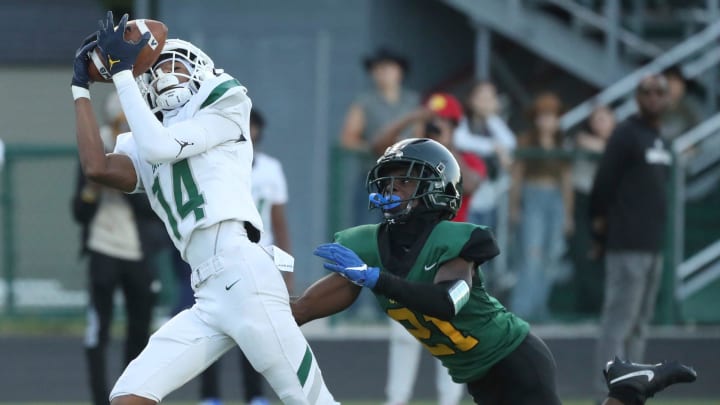 West Bloomfield receiver Elisha Durham catches a touchdown pass against Birmingham Groves defender Chris Little during first-half action at Birmingham Groves on Thursday, Aug. 31, 2023.