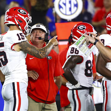 Sep 14, 2024; Lexington, Kentucky, USA; Georgia Bulldogs head coach Kirby Smart talks to quarterback Carson Beck (15) on the sidelines during the first quarter against the Kentucky Wildcats at Kroger Field. Mandatory Credit: Carter Skaggs-Imagn Images