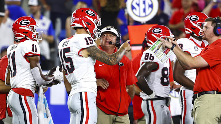 Sep 14, 2024; Lexington, Kentucky, USA; Georgia Bulldogs head coach Kirby Smart talks to quarterback Carson Beck (15) on the sidelines during the first quarter against the Kentucky Wildcats at Kroger Field. Mandatory Credit: Carter Skaggs-Imagn Images