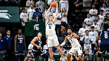 Michigan State's Jaxon Kohler, center, gains possession after blocking Monmouth's Jack Collins, left, during the second half on Monday, Nov. 4, 2024, at the Breslin Center in East Lansing.