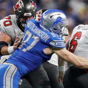 Detroit Lions defensive end Aidan Hutchinson (97) tackles Tampa Bay Buccaneers quarterback Baker Mayfield (6) during the second half of the NFC divisional round at Ford Field in Detroit on Sunday, Jan. 21, 2024.